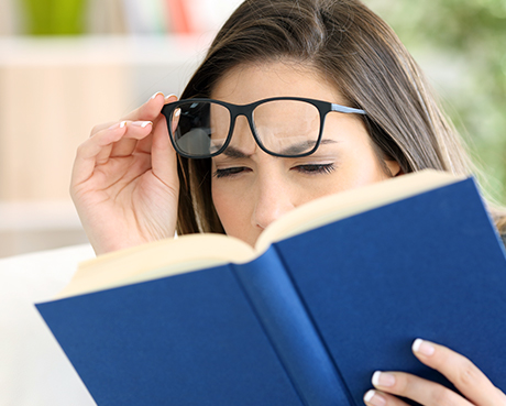 nearsighted woman reading a book